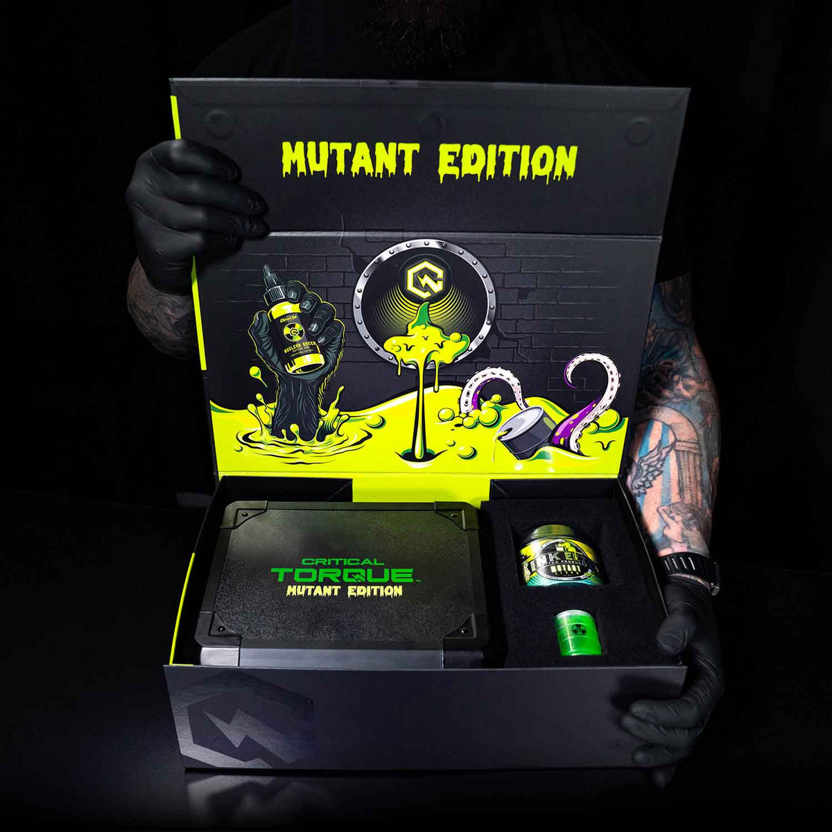 Mutant Edition product packaging held by a gloved hand against a dark background