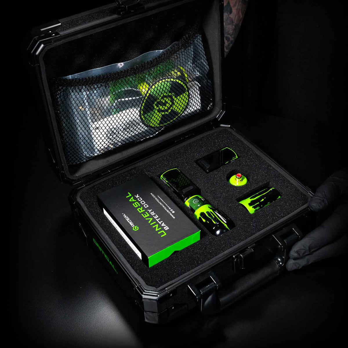 Black case with green and black Critical Torque inside, on a dark background