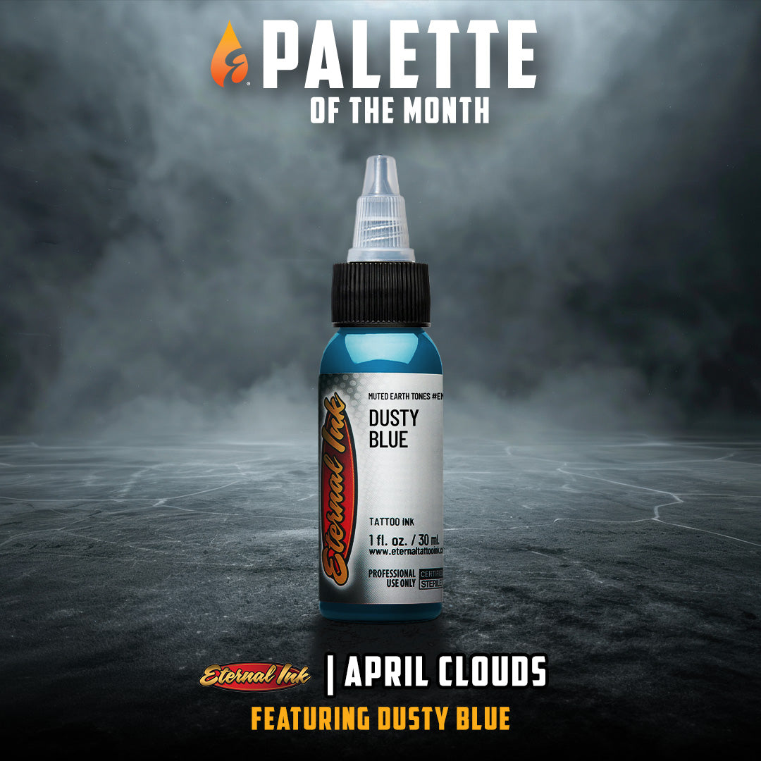Bottle of tattoo ink labeled 'Dusty Blue' with 'Palette of the Month' text on a dark background.